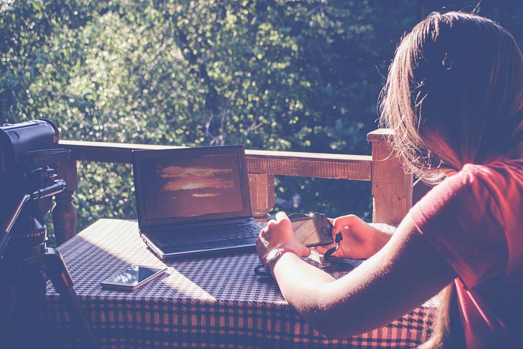 Girl working with notebook in the garden